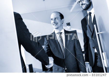 Group of confident business people greeting with a handshake at business meeting in modern office or closing the deal agreement by shaking hands. Group of confident business people greeting with a handshake at business meeting in modern office or closing the deal agreement by shaking hands. 83101247