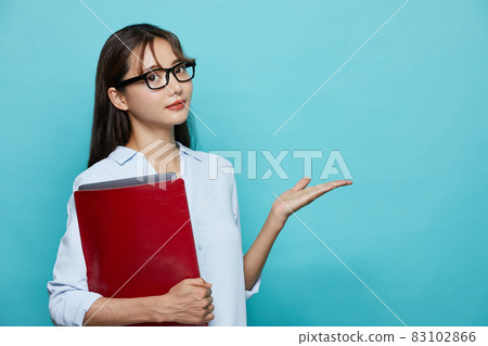 Blue background business portrait of young woman Blue background business portrait of young woman 83102866