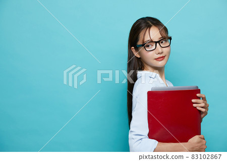 Blue background business portrait of young woman 83102867
