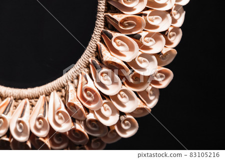 Handmade necklace made of spiral shells lays over black Handmade necklace made of spiral shells lays over black 83105216
