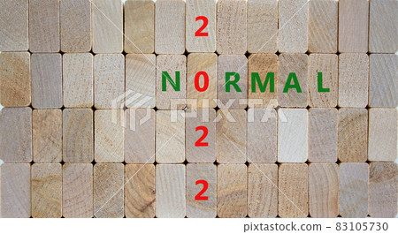 Symbol of covid-19 normal in 2022. Wooden blocks with words 'normal 2022'. Beautiful wooden background, copy space. Medical, covid-19 normal in 2022 concept. Symbol of covid-19 normal in 2022. Wooden blocks with words 'normal 2022'. Beautiful wooden background, copy space. Medical, covid-19 normal in 2022 concept. 83105730
