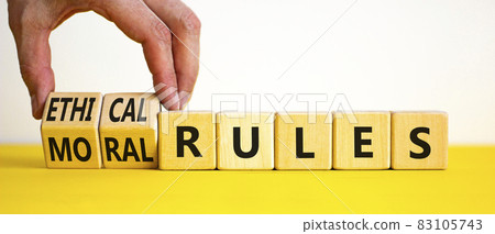 Ethical or moral rules symbol. Businessman turns wooden cubes and changes words 'ethical rules' to 'moral rules' on a beautiful white background. Business, ethical or moral rules concept. Copy space. Ethical or moral rules symbol. Businessman turns wooden cubes and changes words 'ethical rules' to 'moral rules' on a beautiful white background. Business, ethical or moral rules concept. Copy space. 83105743