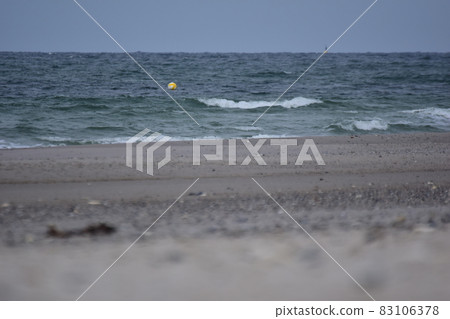 Different focuses of a beach against the ocean with a small floating buoy 83106378