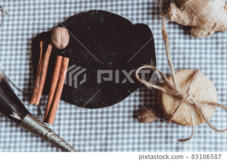 Cat drinking milk. Close up of homemade ginger cookies, cinnamon, ginger with cup of milk on a towel wooden table. Copy space. Retro toned image, flat lay Cat drinking milk. Close up of homemade ginger cookies, cinnamon, ginger with cup of milk on a towel wooden table. Copy space. Retro toned image, flat lay 83106587