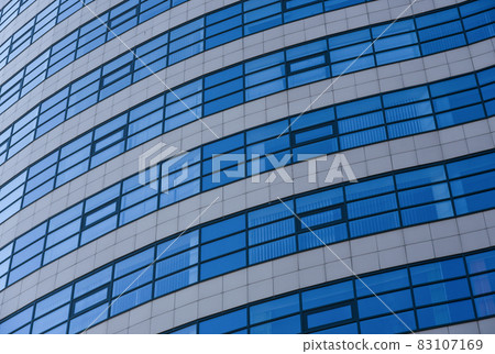 Curved windows on the wall of a modern building Curved windows on the wall of a modern building 83107169