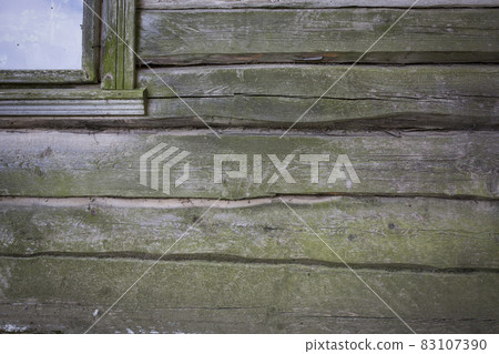 Wooden logs of an old house. Close-up. Weathered natural gray wood texture. Background. Horizontal photo Wooden logs of an old house. Close-up. Weathered natural gray wood texture. Background. Horizontal photo 83107390