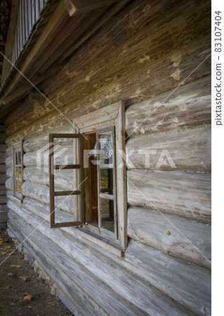 Abandoned wooden house in a dead village. Golden autumn. Old rustic architecture. Abandoned wooden house in a dead village. Golden autumn. Old rustic architecture. 83107404