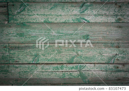 Wooden logs of an old house. Close-up. Weathered green wood texture. Background. Horizontal photo. Wooden logs of an old house. Close-up. Weathered green wood texture. Background. Horizontal photo. 83107473