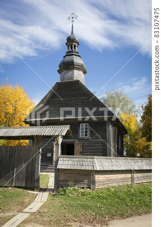 Autumn landscape. Yellow foliage on the trees and a rustic wooden church. Autumn landscape. Yellow foliage on the trees and a rustic wooden church. 83107475