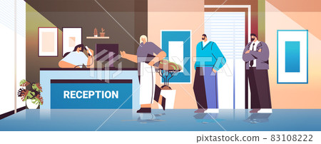 business people customers or travelers standing at reception desk and talking to receptionist 83108222