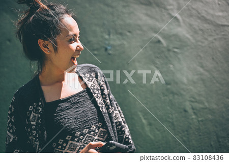 Series photo of happy young women in enjoying emotion with green background of real cement wall 83108436