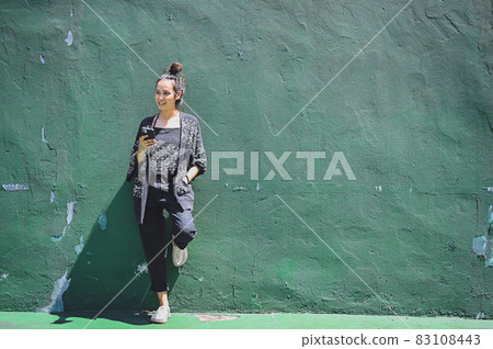 Series photo of happy young women in enjoying emotion with green background of real cement wall 83108443