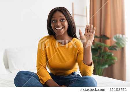 Black Female Waving Hand Communicating Via Video Call At Home Black Female Waving Hand Communicating Via Video Call At Home 83108751