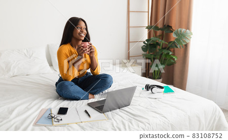African American Lady Using Laptop Enjoying Coffee In Bedroom, Panorama African American Lady Using Laptop Enjoying Coffee In Bedroom, Panorama 83108752