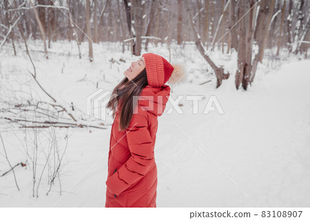 Winter outdoor happy relaxing Asian woman breathing fresh cold winter air serene and zen doing wellness walk walking outside in forest nature for mental health Winter outdoor happy relaxing Asian woman breathing fresh cold winter air serene and zen doing wellness walk walking outside in forest nature for mental health 83108907