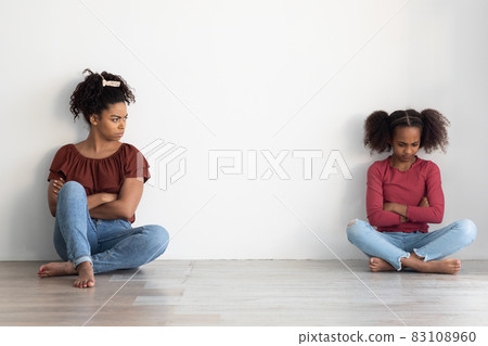 Sad black lady mother and female kid daughter having fight 83108960
