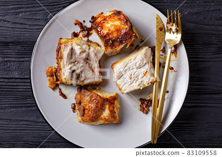 Roasted pork loin chopped into pieces, close-up 83109558