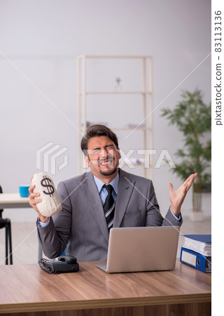 Young male employee in remuneration concept Young male employee in remuneration concept 83113136