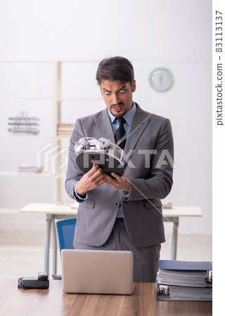 Young male employee in time management concept 83113137