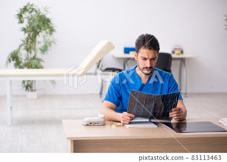 Young male doctor radiologist sitting in the clinic 83113463