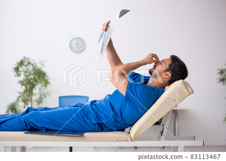 Young male doctor radiologist sitting in the clinic 83113467