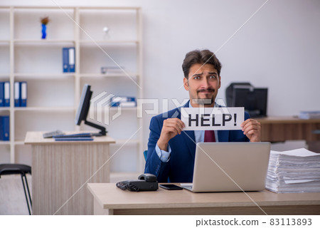 Young businessman employee and too much work in the office Young businessman employee and too much work in the office 83113893
