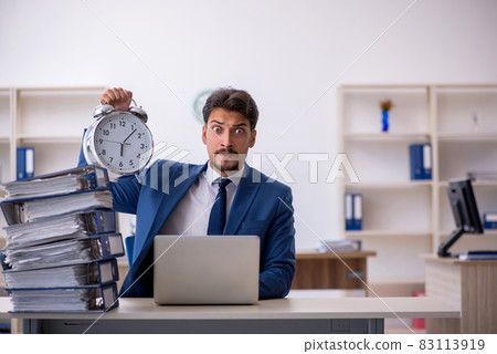 Young businessman employee unhappy with excessive work in the of 83113919