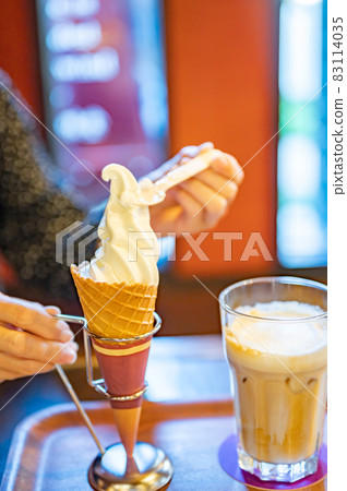 Middle-aged woman eating soft serve ice cream 83114035