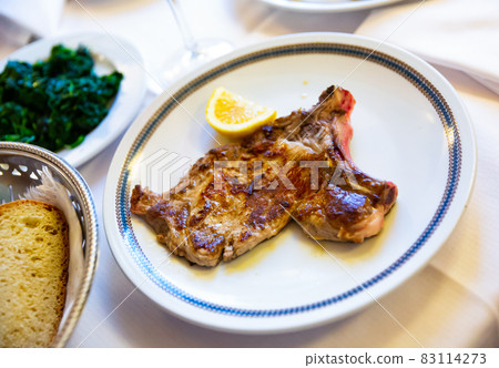 Italian dish - traditional veal chop with lemon 83114273