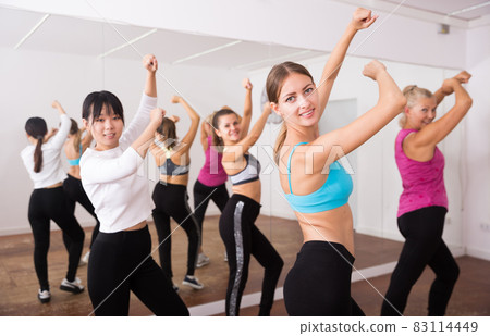 Fitness women practicing zumba movements 83114449