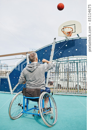 Man in wheelchair playing basketball 83114675