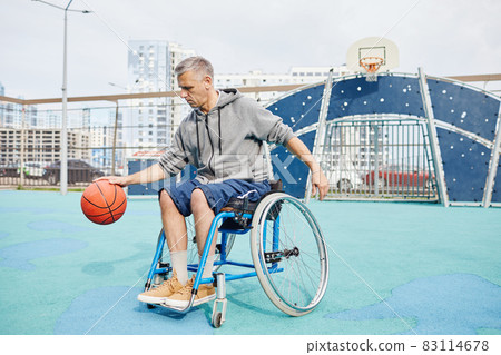 Man with disability laying basketball 83114678