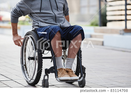 Man sitting in wheelchair Man sitting in wheelchair 83114708