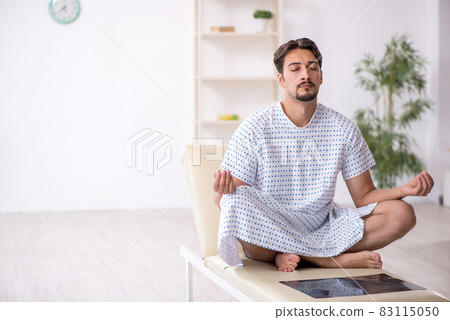 Young male patient waiting for doctor at the hospital 83115050