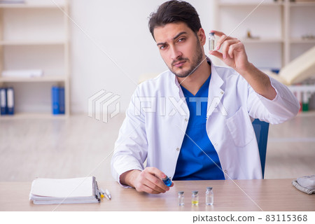 Young male doctor in vaccination concept 83115368