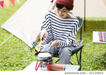 Young woman enjoying camping 83116602