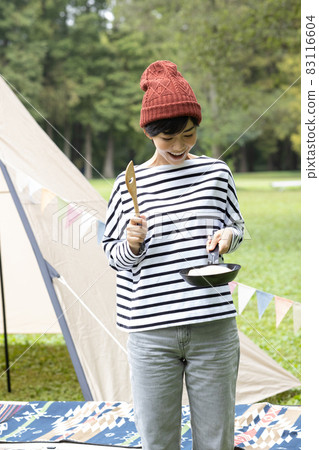 Young woman enjoying camping 83116604
