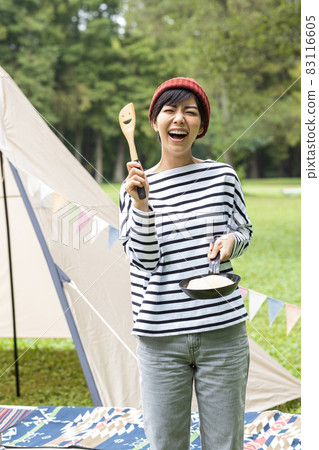 Young woman enjoying camping 83116605