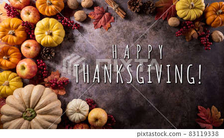 Thanksgiving background concept with fall leaves, pumpkin and seasonal autumnal decor on dark stone background. Thanksgiving background concept with fall leaves, pumpkin and seasonal autumnal decor on dark stone background. 83119338