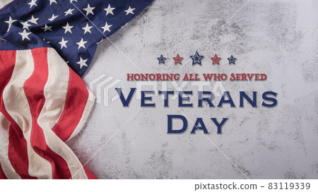 Happy Veterans Day concept. American flags against a dark stone  background. November 11. 83119339