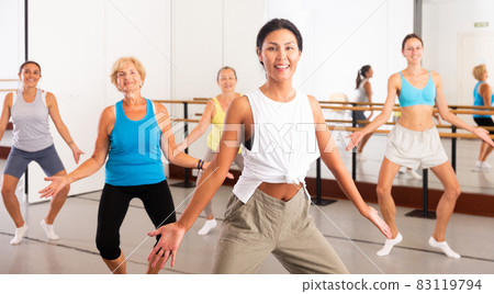 Modern active females dancing excited posing in studio 83119794