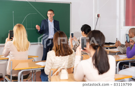 Teacher explaining new theme to adult students Teacher explaining new theme to adult students 83119799