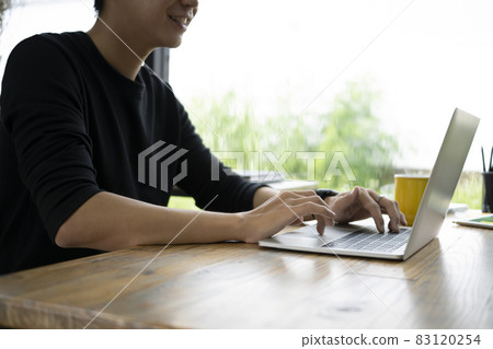 Young man working with computer laptop in creative office. Young man working with computer laptop in creative office. 83120254