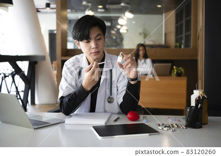 Doctor holding syringe and bottle of vaccine. Healthcare and Medical concept. Doctor holding syringe and bottle of vaccine. Healthcare and Medical concept. 83120260