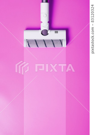 A white vacuum cleaner brush on a pink background. 83120324