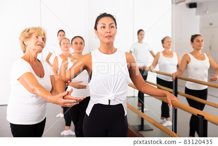 Women training ballet moves with trainer Women training ballet moves with trainer 83120435