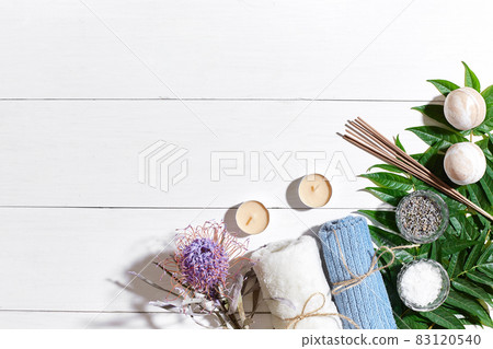 Spa set with sea salt, essential oil, soap and towel decorated with dry flower on white wooden background Spa set with sea salt, essential oil, soap and towel decorated with dry flower on white wooden background 83120540