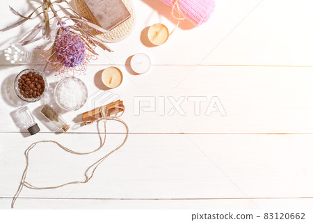 Spa set with sea salt, essential oil, soap and towel decorated with dry flower on white wooden background. Sun flare Spa set with sea salt, essential oil, soap and towel decorated with dry flower on white wooden background. Sun flare 83120662