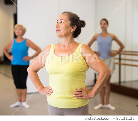 Group of adult people practicing dance techniques Group of adult people practicing dance techniques 83121125