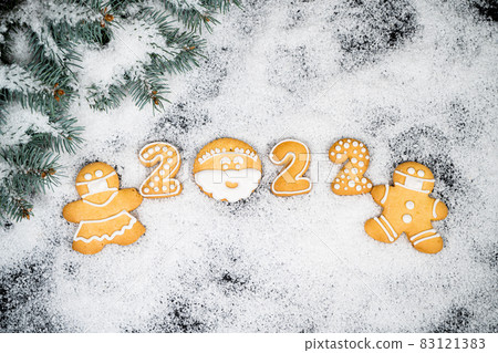 Christmas background with gingerbread on winter snow. Holiday mood card. Top view, copy space. Family traditions, DIY, celebration concept. Festive background with homemade gingerbread cookies. Christmas background with gingerbread on winter snow. Holiday mood card. Top view, copy space. Family traditions, DIY, celebration concept. Festive background with homemade gingerbread cookies. 83121383